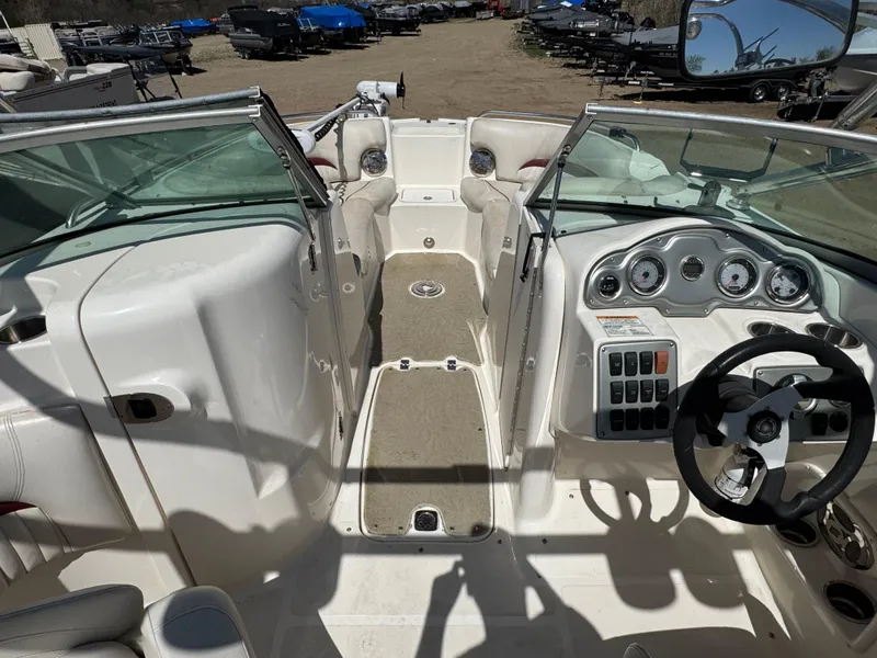 Slide: The Image of 2008 Hurricane SunDeck 2400 IO boat seating with white upholstery and cup holders. - 17