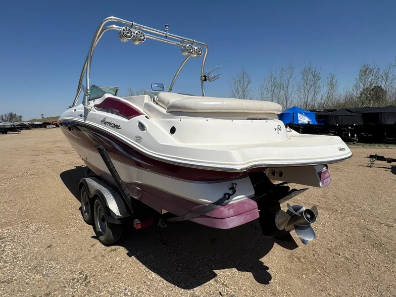Slide: The Image of 2008 Hurricane SunDeck 2400 IO boat in a garage, rear view with trailer. - 4