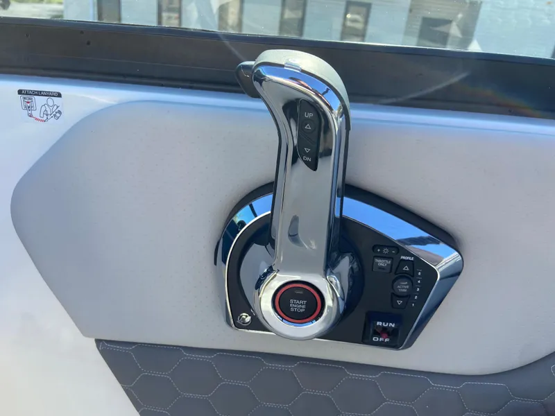 Slide: The Image of Throttle control of 2023 Sea Ray SDX 250 boat, featuring a sleek chrome finish. - 10