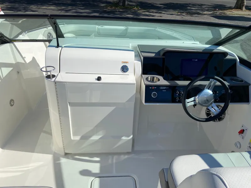 Slide: The Image of 2023 Sea Ray SDX 250 boat cockpit with modern steering and control panel. - 11