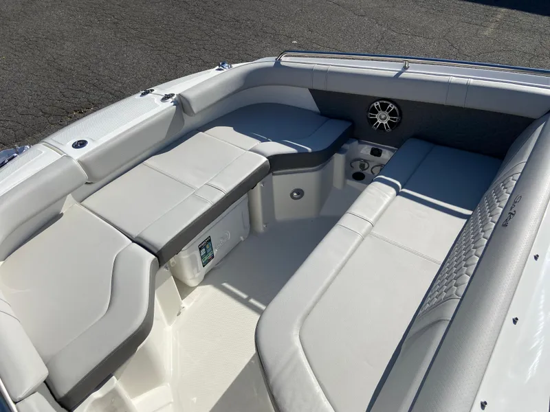 Slide: The Image of 2023 Sea Ray SDX 250 boat interior with white cushioned seating and speaker system. - 14