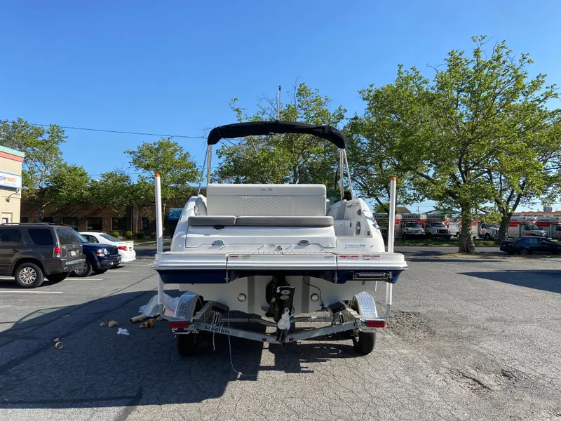 Slide: The Image of 2023 Sea Ray SDX 250 boat parked in a lot, rear view, sunny day. - 4