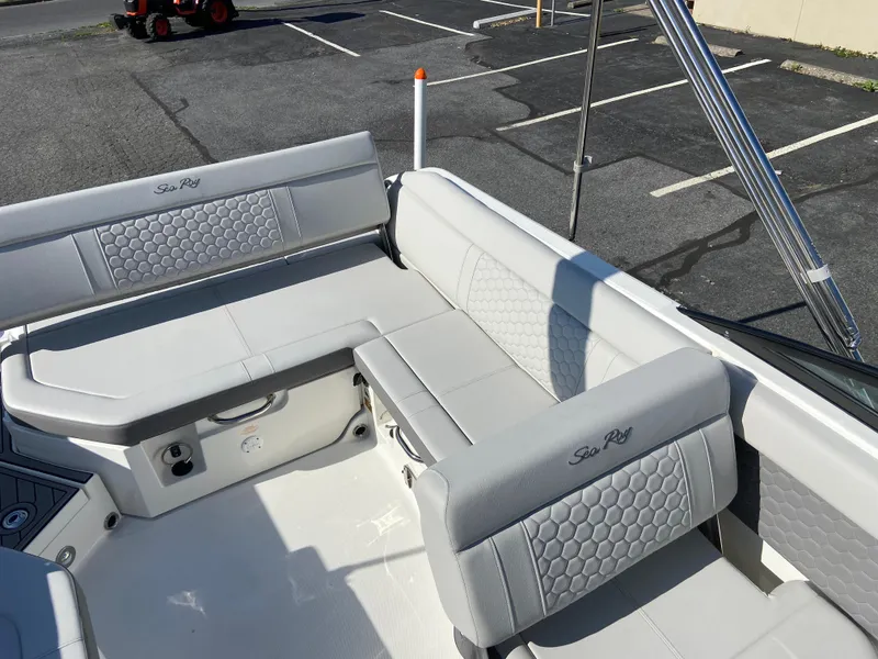 Slide: The Image of 2023 Sea Ray SDX 250 boat interior with gray seating and hexagonal pattern. - 7