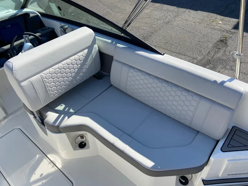 Slide: The Image of 2023 Sea Ray SDX 250 boat interior with white cushioned seating and hexagonal pattern. - 8