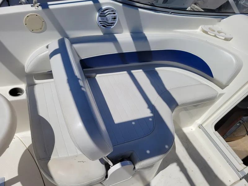 Slide: The Image of 2005 Bayliner 265 boat interior seating with white and blue upholstery. - 10