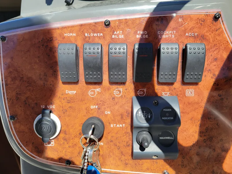 Slide: The Image of Control panel of a 2005 Bayliner 265 boat with switches and ignition. - 14