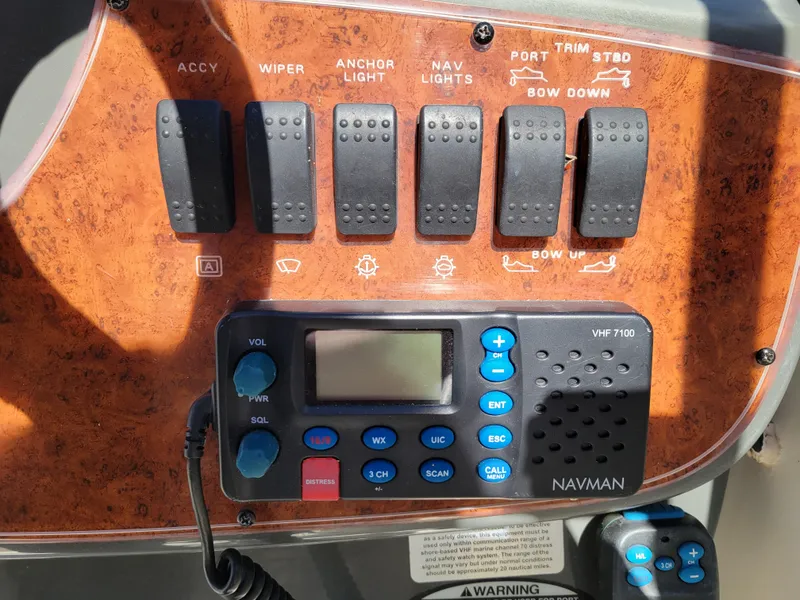 Slide: The Image of Control panel of a 2005 Bayliner 265 boat with Navman VHF 7100 radio. - 15
