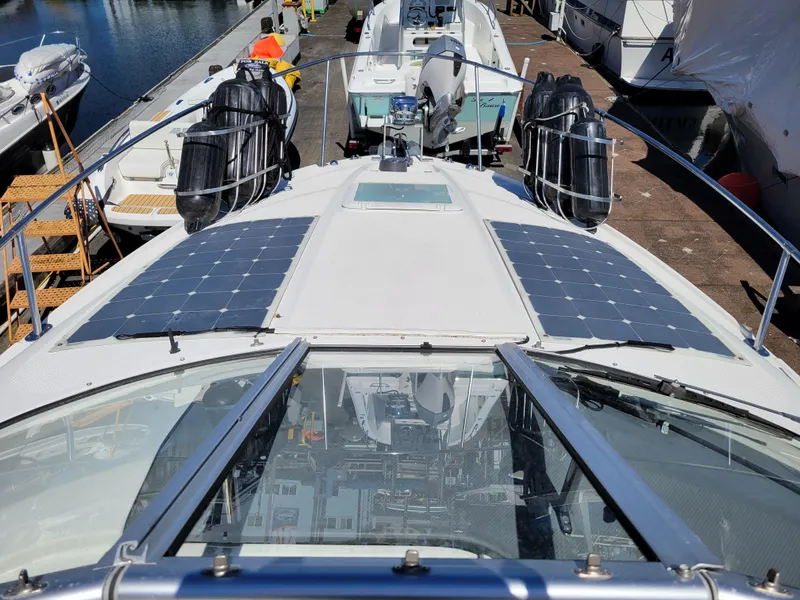Slide: The Image of 2005 Bayliner 265 boat with solar panels docked at a marina. - 17