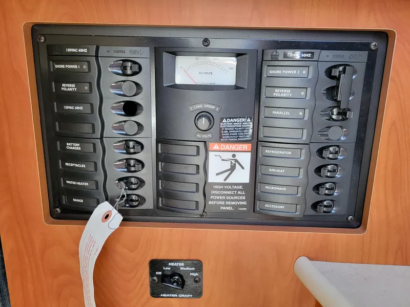 Slide: The Image of Control panel of a 2005 Bayliner 265 boat with various switches and warning labels. - 22