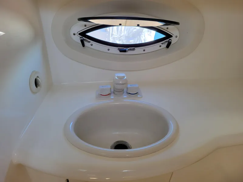 Slide: The Image of 2005 Bayliner 265 boat interior sink with oval window. - 29