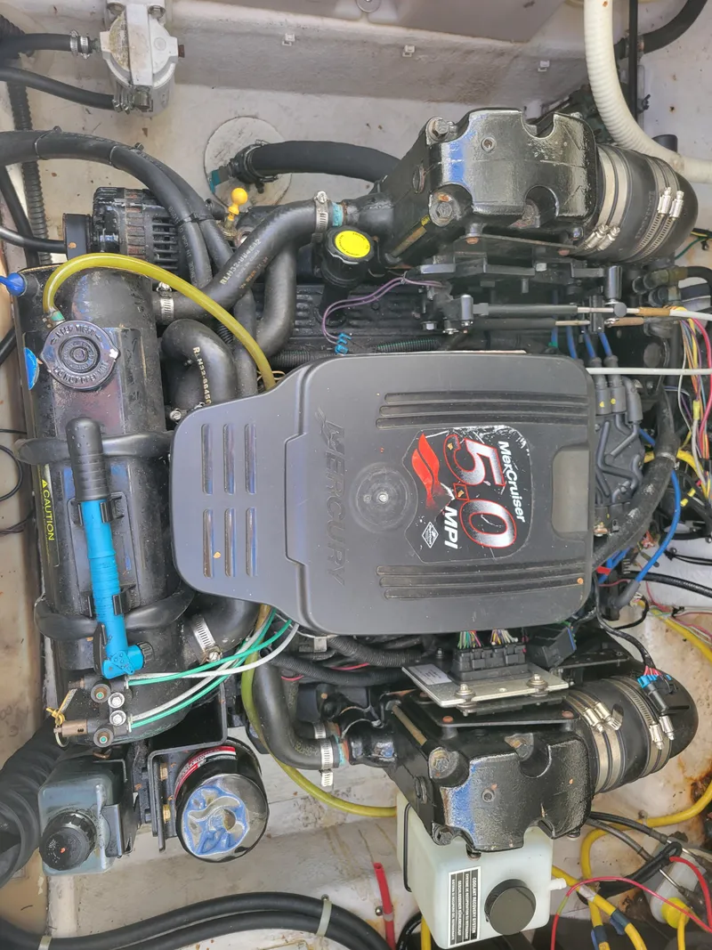 Slide: The Image of Engine of a 2005 Bayliner 265 boat, showcasing complex wiring and components. - 33