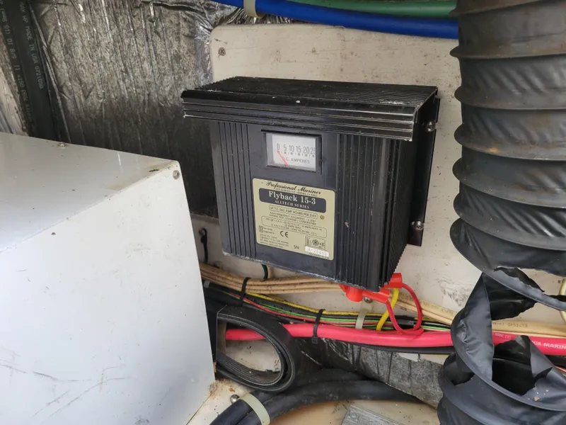 Slide: The Image of Electrical system inside a 2005 Bayliner 265 boat, featuring a Flyback 15-3 charger. - 35