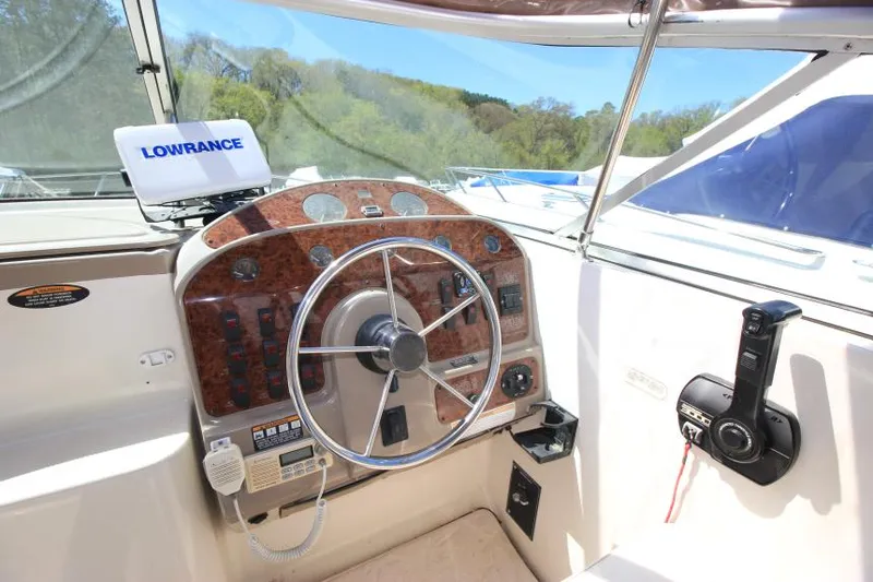 Slide: The Image of 1999 Maxum 2800 SCR boat cockpit with steering wheel and navigation equipment. - 10