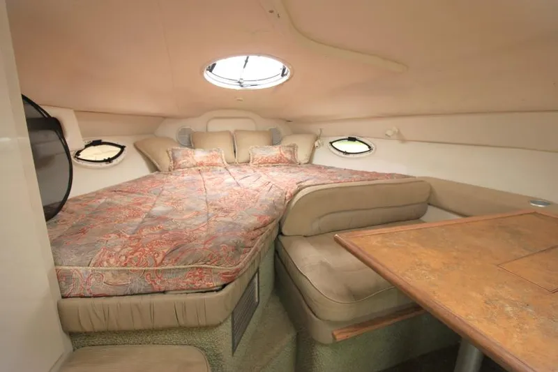 Slide: The Image of 1999 Maxum 2800 SCR cabin interior with cozy bed and dining area. - 13