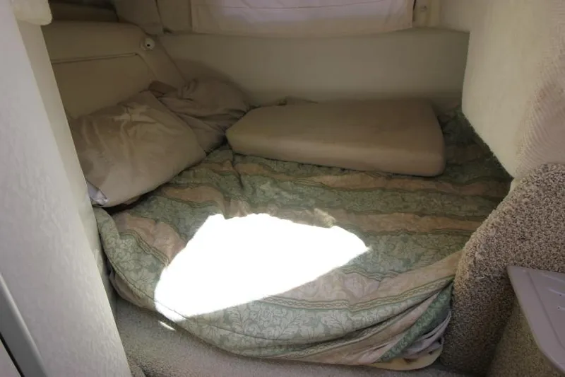Slide: The Image of Cozy sleeping area in a 1999 Maxum 2800 SCR boat cabin. - 17