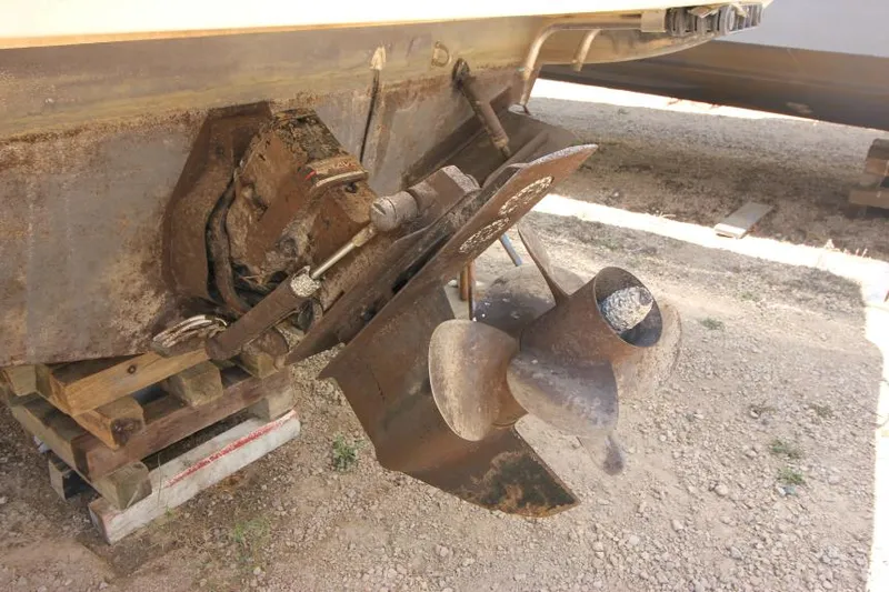 Slide: The Image of 1999 Maxum 2800 SCR boat propeller and stern drive on dry land. - 3