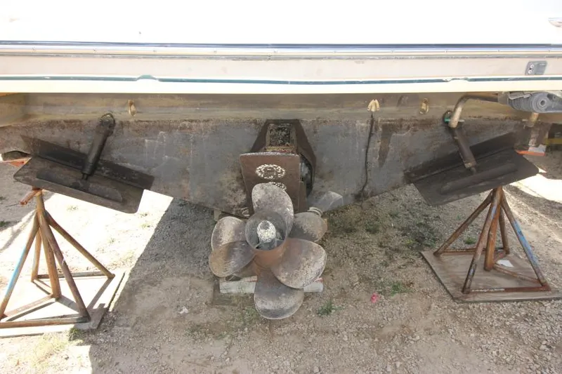Slide: The Image of 1999 Maxum 2800 SCR boat stern with propeller and trim tabs on stands. - 4
