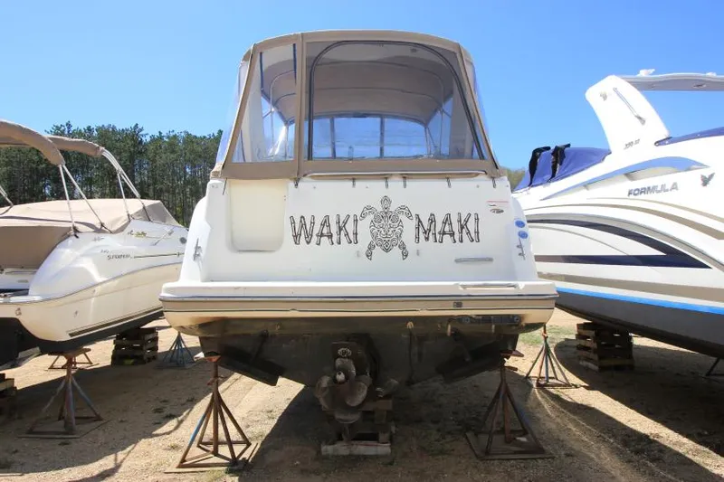 Slide: The Image of 1999 Maxum 2800 SCR boat on stands, featuring "Waki Maki" name and turtle graphic. - 5
