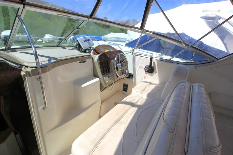Slide: The Image of 1999 Maxum 2800 SCR boat interior with steering wheel and seating area. - 8