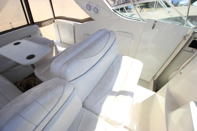 Slide: The Image of 1999 Maxum 2800 SCR boat interior with white seating and table. - 9