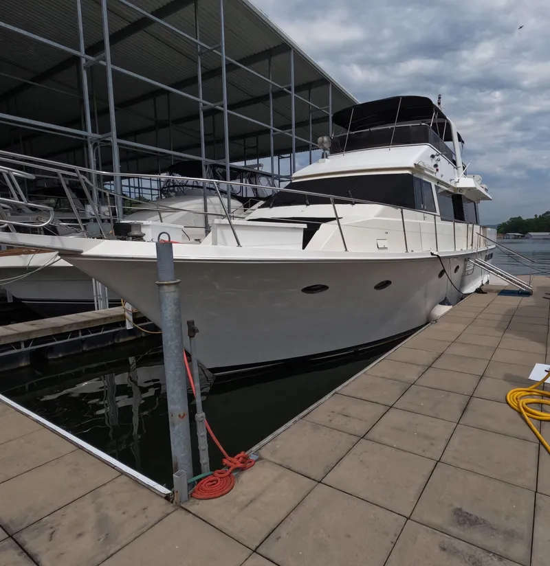Slide: The Image of 1988 Viking Gulfstar 55 MY yacht docked at marina under cloudy sky. - 0