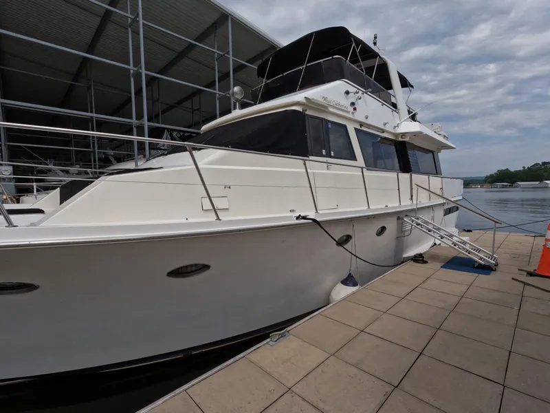 Slide: The Image of 1988 Viking Gulfstar 55 MY yacht docked at marina under cloudy sky. - 1