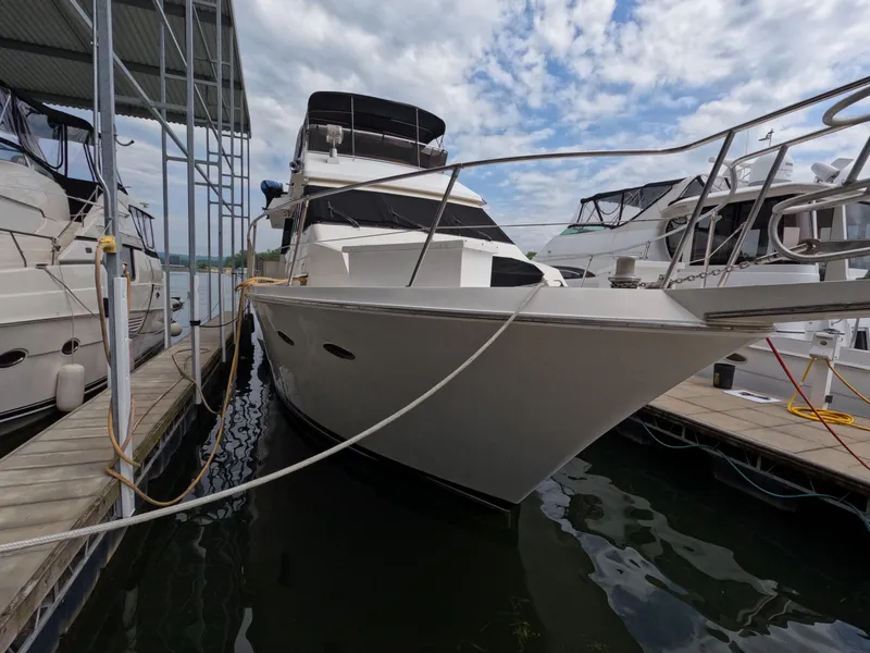 Slide: The Image of 1988 Viking Gulfstar 55 MY yacht docked at marina under cloudy sky. - 10