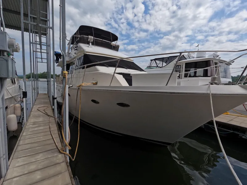 Slide: The Image of 1988 Viking Gulfstar 55 MY yacht docked at marina under cloudy sky. - 11