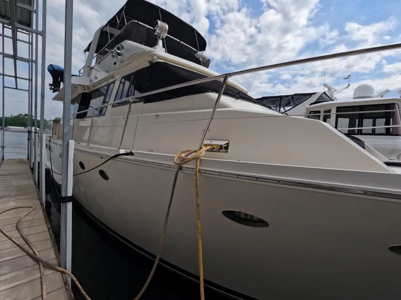Slide: The Image of 1988 Viking Gulfstar 55 MY yacht docked at marina under cloudy sky. - 12