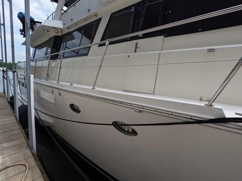 Slide: The Image of 1988 Viking Gulfstar 55 MY yacht docked, showcasing sleek white exterior and railing. - 13