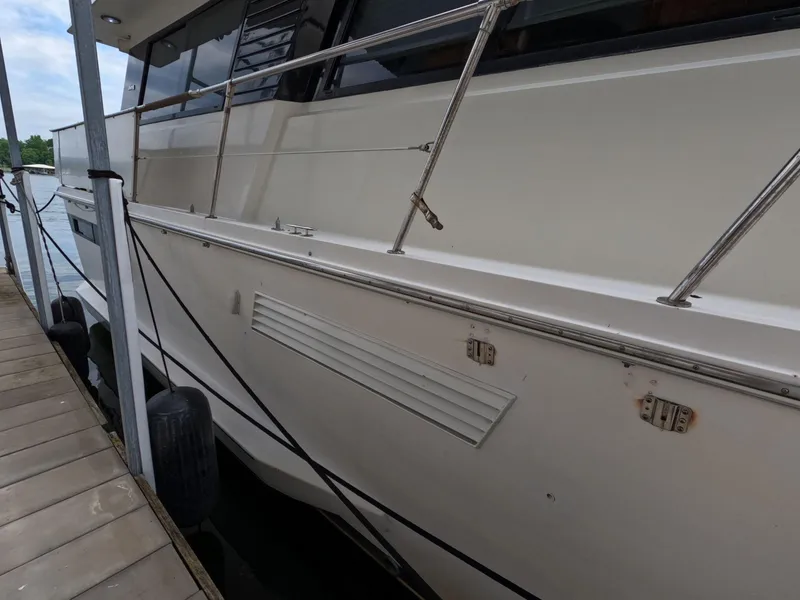 Slide: The Image of 1988 Viking Gulfstar 55 MY yacht docked, showcasing sleek white exterior and railing. - 15