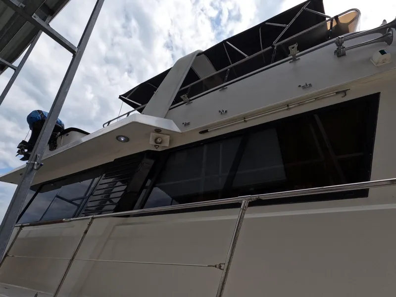 Slide: The Image of 1988 Viking Gulfstar 55 MY yacht, exterior view under cloudy sky. - 16