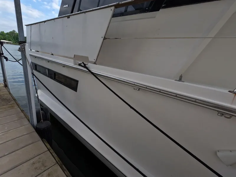 Slide: The Image of 1988 Viking Gulfstar 55 MY yacht docked, showcasing sleek white exterior and railing. - 17