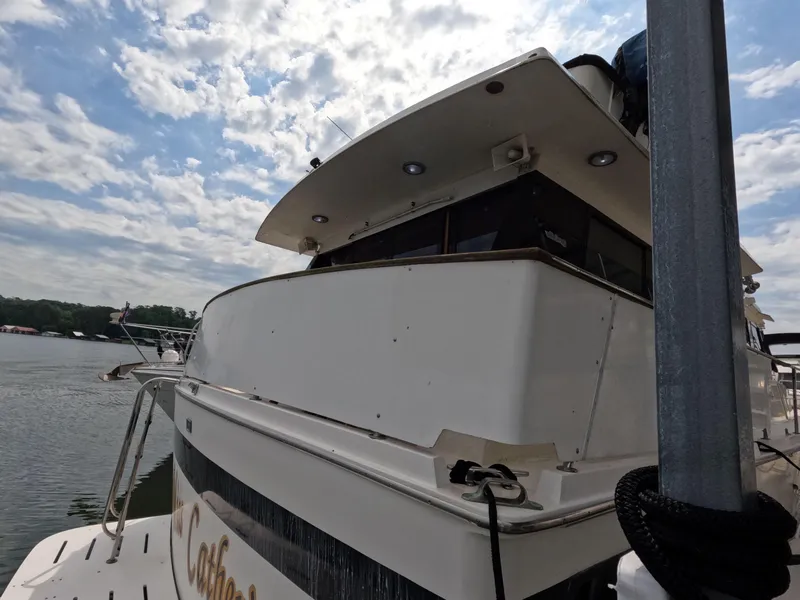 Slide: The Image of 1988 Viking Gulfstar 55 MY yacht docked under a partly cloudy sky. - 19