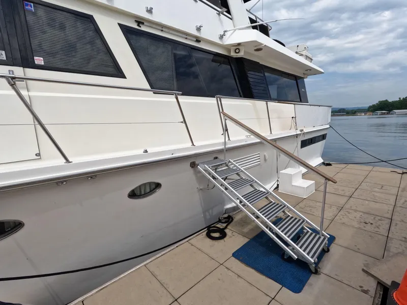 Slide: The Image of 1988 Viking Gulfstar 55 MY yacht docked with boarding stairs and sleek design. - 2