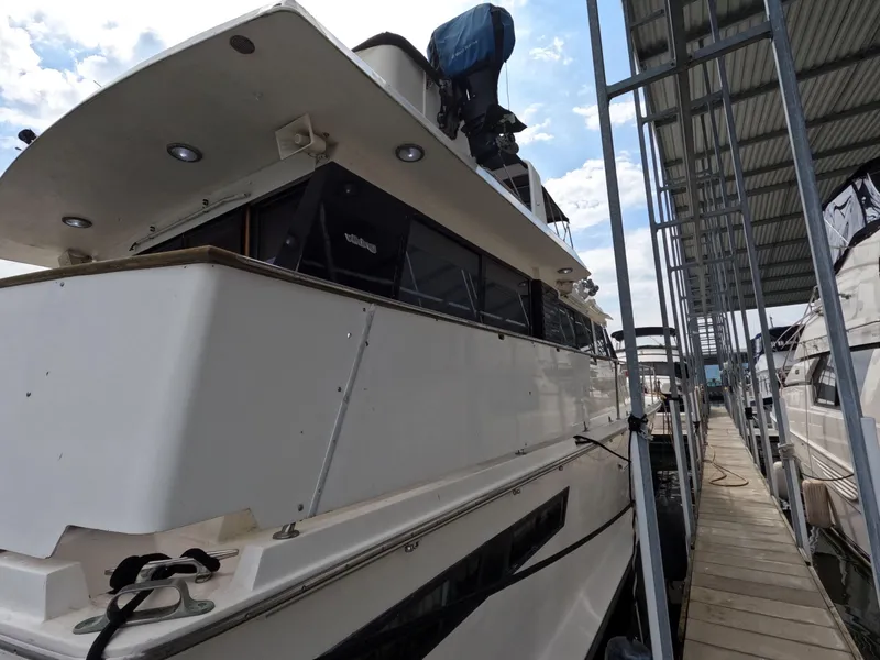 Slide: The Image of 1988 Viking Gulfstar 55 MY yacht docked at marina under a covered slip. - 22