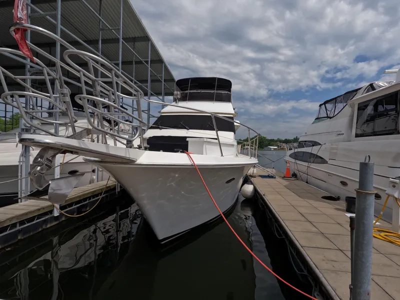 Slide: The Image of 1988 Viking Gulfstar 55 MY yacht docked at marina under cloudy sky. - 23