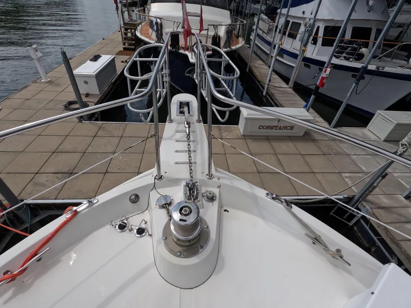 Slide: The Image of 1988 Viking Gulfstar 55 MY yacht bow at dock, showcasing deck and railing. - 24