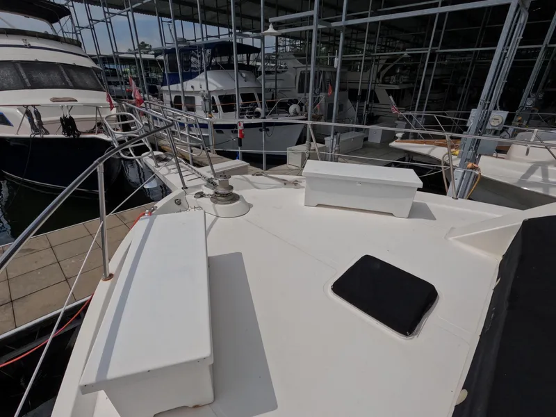 Slide: The Image of 1988 Viking Gulfstar 55 MY yacht docked in marina, surrounded by other boats. - 27