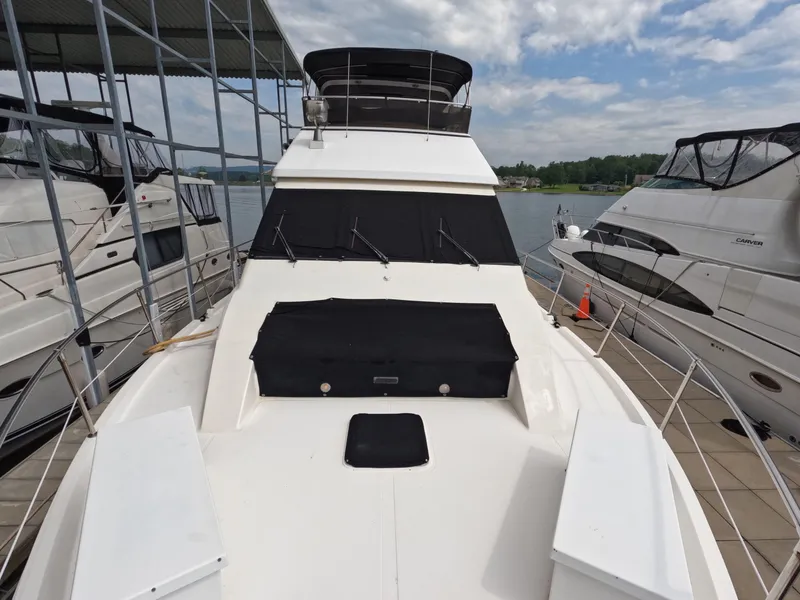 Slide: The Image of 1988 Viking Gulfstar 55 MY yacht docked, showcasing sleek design and spacious deck. - 28