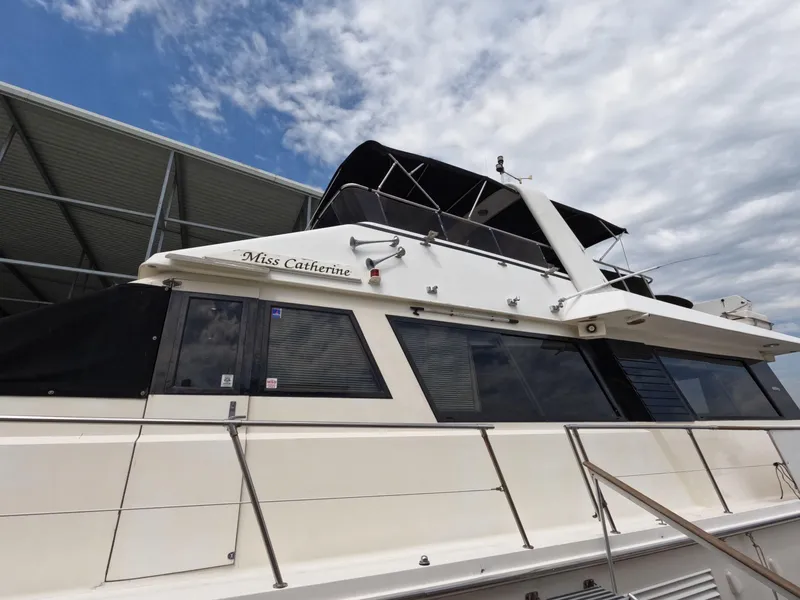 Slide: The Image of 1988 Viking Gulfstar 55 MY yacht docked under a cloudy sky. - 3