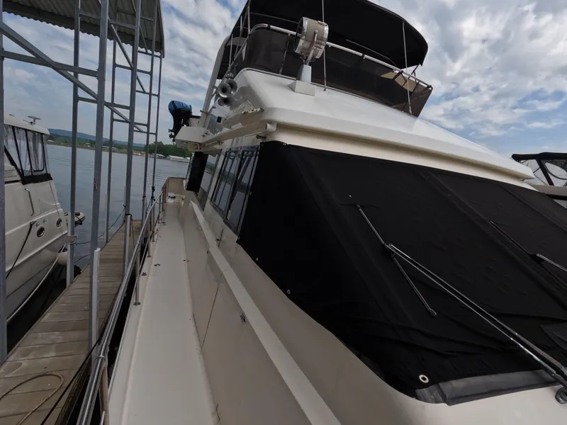 Slide: The Image of 1988 Viking Gulfstar 55 MY yacht docked under a covered marina. - 31