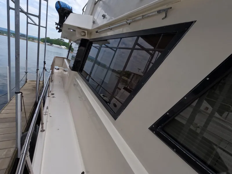 Slide: The Image of 1988 Viking Gulfstar 55 MY yacht docked, showcasing sleek windows and side deck. - 33