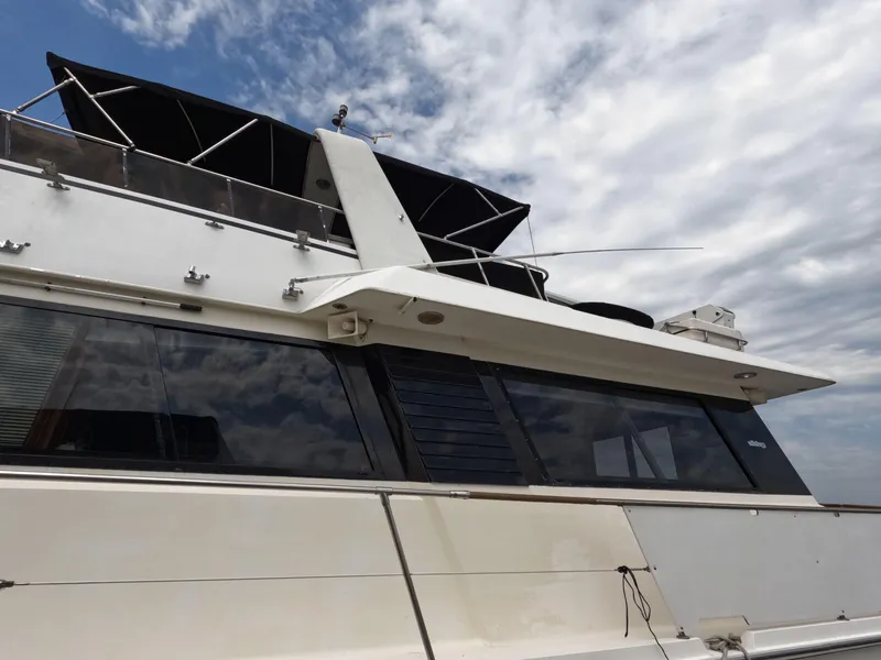 Slide: The Image of 1988 Viking Gulfstar 55 MY yacht with sleek design under cloudy sky. - 4