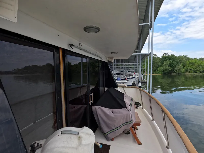 Slide: The Image of 1988 Viking Gulfstar 55 MY yacht docked, featuring covered deck and serene water view. - 44