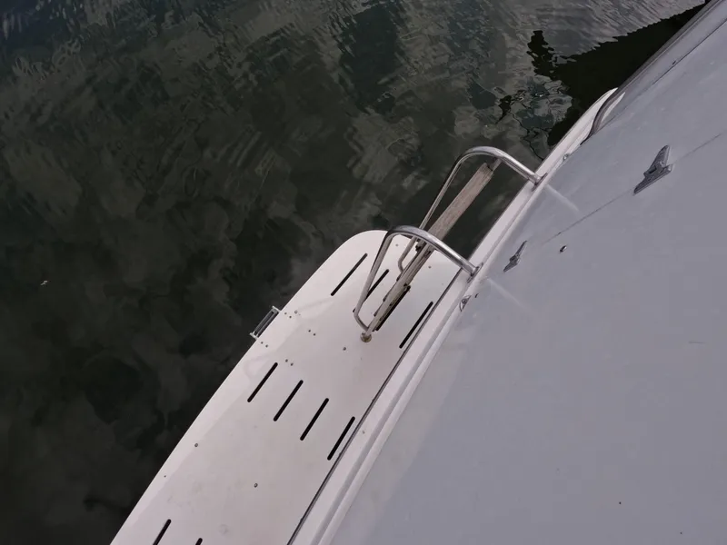 Slide: The Image of 1988 Viking Gulfstar 55 MY yacht swim platform with ladder, reflecting on water. - 47