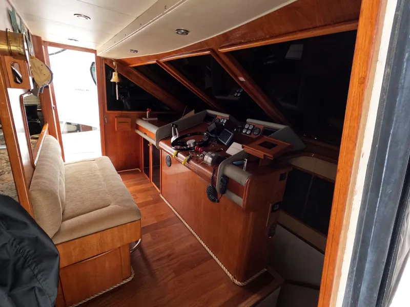 Slide: The Image of 1988 Viking Gulfstar 55 MY yacht interior with wooden helm and seating area. - 49