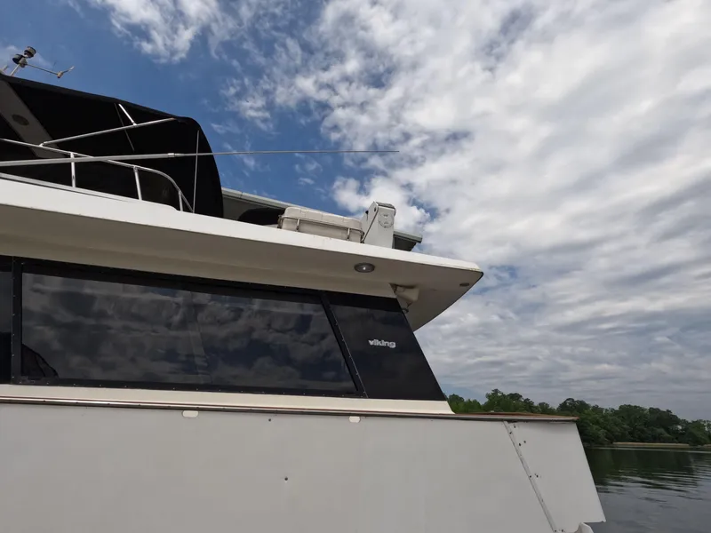 Slide: The Image of 1988 Viking Gulfstar 55 MY yacht against a cloudy sky and calm water. - 6