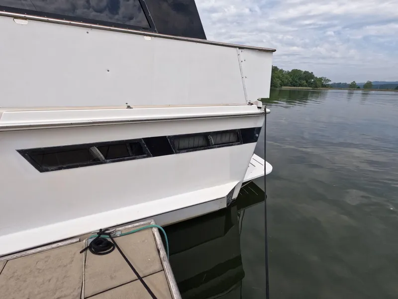 Slide: The Image of 1988 Viking Gulfstar 55 MY yacht docked on calm water under cloudy sky. - 7