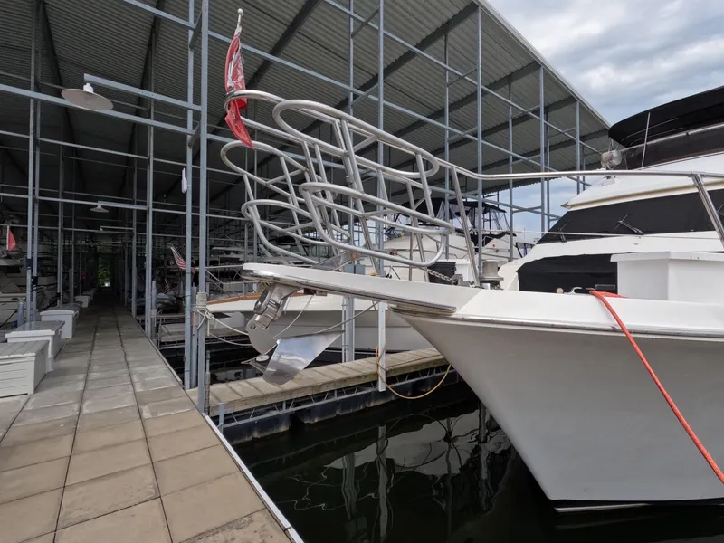 Slide: The Image of 1988 Viking Gulfstar 55 MY yacht docked in a marina under a metal canopy. - 8